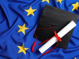 Graduation cap and diploma on flag