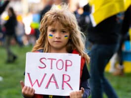 Childr holding Stop War sign